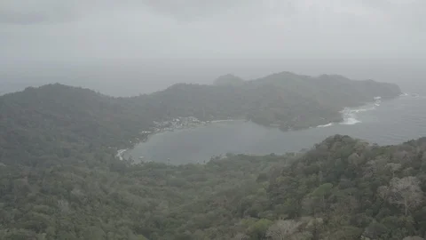 Misty aerial ascends while tilting down to reveal Sapzurro, Colombia Stock-Footage 108045803