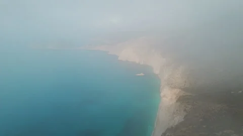 Misty aerial view of coastal cliffs fading into blue horizon in Kefalonia Island Stock Footage 327615142