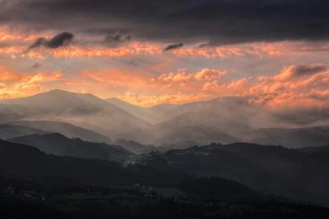 Misty and Cloudy sunset Stock Photos