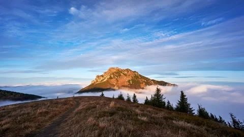 Misty clouds flow like the sea through the Misty Mountains at sunrise Stock Footage 295358328