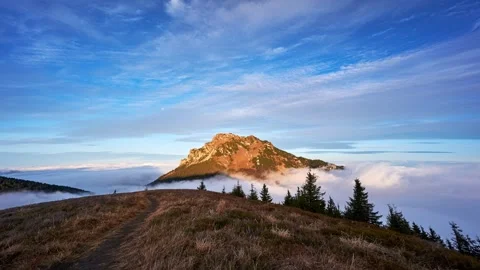 Misty clouds flow like the sea through the Misty Mountains at sunrise Stock Footage 295763726