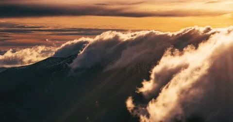 Misty clouds motion fast over alpine mountains ridge nature at sunrise Time Stock Footage 230171926
