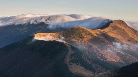 Misty clouds over alpine mountains ridge in autumn morning nature time lapse Stock Footage 108632988