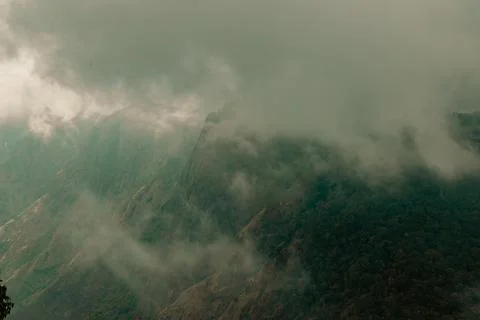 Misty clouds passing on top of the mountains or hills Stock Photos