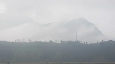 Misty, cloudy landscape of Bromo Volcano in Java, with volcanic terrain 動画素材 312425279
