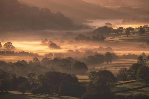 A misty Dove Valley sunrise in the Peak District National Park, UK. Stock Photos