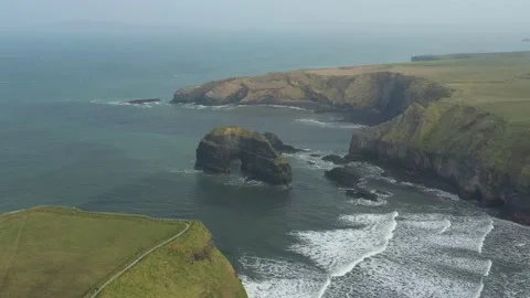 Misty flight over Ballybunion Arch, Co Kerry, Ireland Stock Footage 232720817