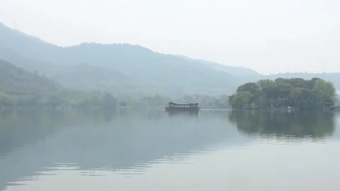 Misty Lake and Mountains with Reflection in Traditional Chinese Style Stock Footage 340148616