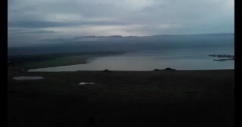 Misty lake with distant hilly landscape in the evening Stock-Footage 314794102