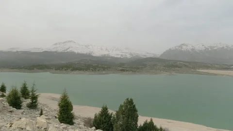 Misty Lake Surrounded by Mountains Stock Footage 282935797