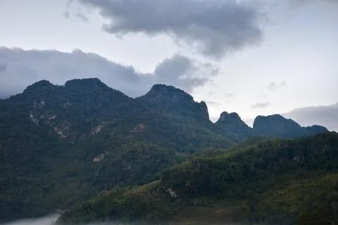 Misty Limestone Mountains Under Cloudy Sky Stock Photos