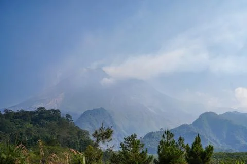 Misty Mount Merapi Volcano Above Tropical Forest in Yogyakarta Fotos Stock