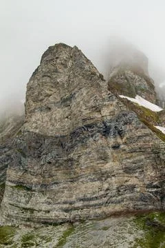Misty Mountain Cliff in Svalbard Stock Photos