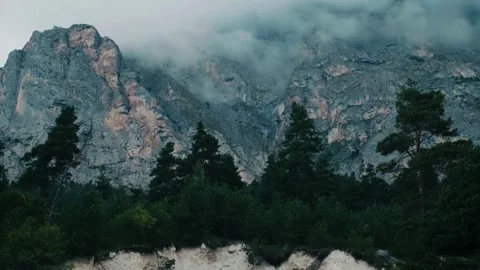 Misty mountain cliffs, dramatic rocky peak, moody alpine scene Stock Footage 311756350
