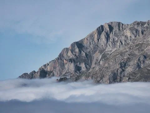 Misty mountain peaks emerging from clouds - Close-up of rocky mountain slop.. Foto stock