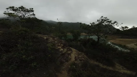 Misty Mountain Reservoir View with Pine Trees and Clouds Stock Footage 335436411