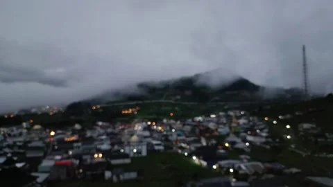 Misty mountain town at twilight with diffused city lights view Stock Footage 304114488