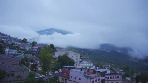Misty Mountain Townscape with Clouds Rolling Over Hills Stock Footage 334129341