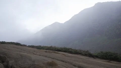 Misty mountain view from Ijen Volcano trail, high above Java's rugged, scenic 動画素材 312426439