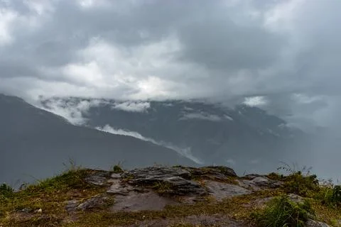 Misty mountains with dramatic cloudy sky at morning in rainy day 写真素材