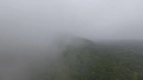 Misty Mountains Wide Drone through Fog Stock Footage 145289031