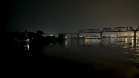 Misty night view of a bridge over a calm river with city lights reflecting .. Stock-Footage 340221478