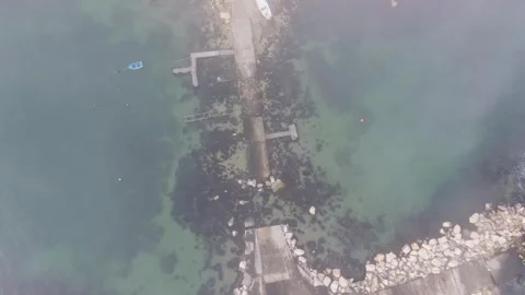 Misty Ocean Waves Surrounding Harbor Breakwater Structure Stock Footage 328826376