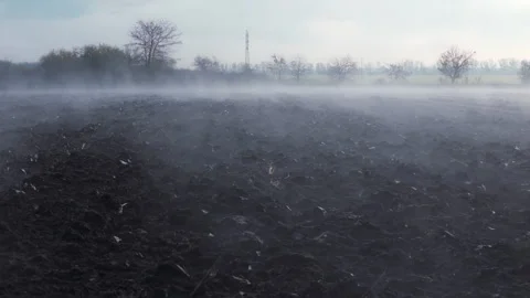 Misty Plowed Field at Dawn. camera flyover low above the ground Stock Footage 322509784