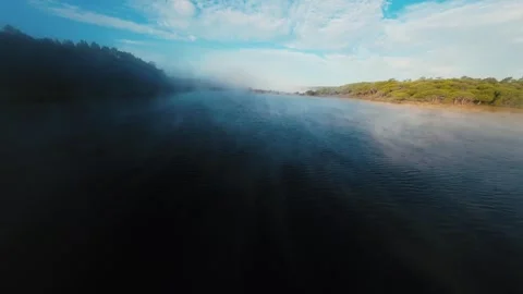 Misty river flows gently under soft dawn light Video stock 340904191