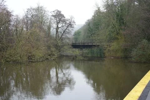 Misty River Scene With Bare Trees And Railway Bridge Reflections, Belper, Stock Photos