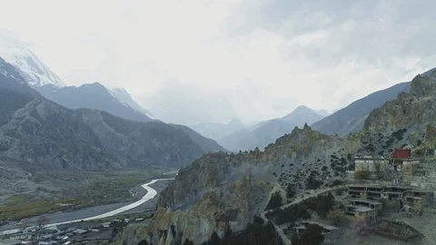 Misty spacious river valley panorama, Braga monastery near crests cliffs, Nepal Stock Footage 124680992