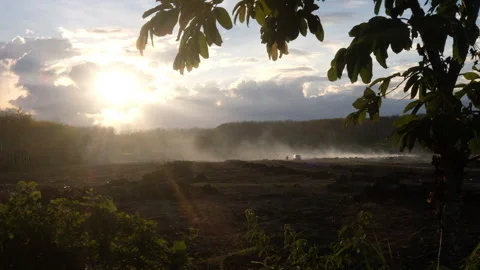 Misty Sunset Over a Rugged Landscape and car with camera paning Stock Footage 305709186
