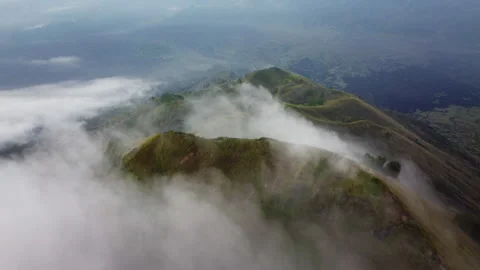 Misty Volcanic Summit Crest Partially Hidden by Moving Fog in Indonesia Stock Footage 342640265