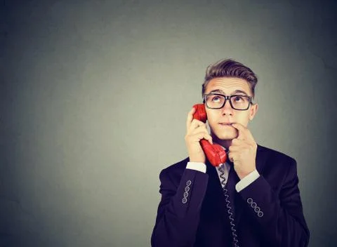 Misunderstanding and distant call. Upset worried confused man talking on a ph Stock Photos