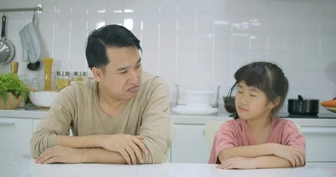 Misunderstanding between upset father and daughter, dad and kid sitting at table Stock Footage 101419659