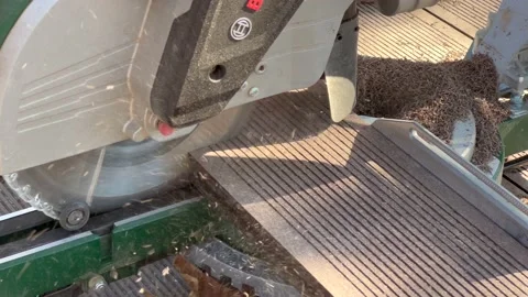 Miter saw. Cutting of composite deck. Shavings Stock Footage 166173757