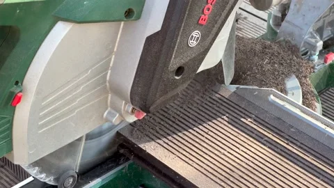 Miter saw. Cutting of composite deck. Shavings Stock Footage 166173839