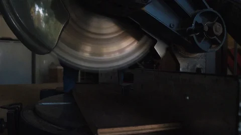 Miter Saw Cutting into Wood Plank Stock Footage 97085853