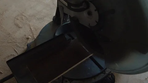 Miter Saw in Slow Motion Cuts into Wooden Plank Stock Footage 97085801