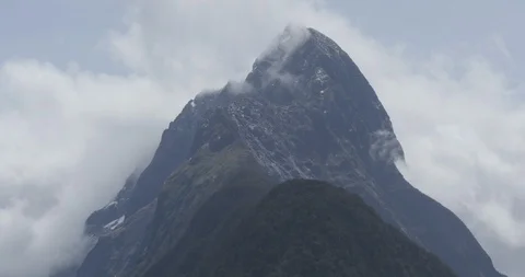 Mitre Peak just visible through clouds in Milford Sound New Zealand Stock Footage 120321471