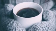 Mittens Holding A Cup Of Steaming Hot Coffee In Winter Stock Footage