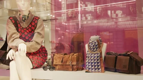 MIU MIU SS26 window display with chic accessories, designer handbags, and Stock Footage 330033602