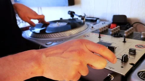 Mix and scratch, hands of a DJ on vinyl and mixer knobs. 스톡 동영상 89734808