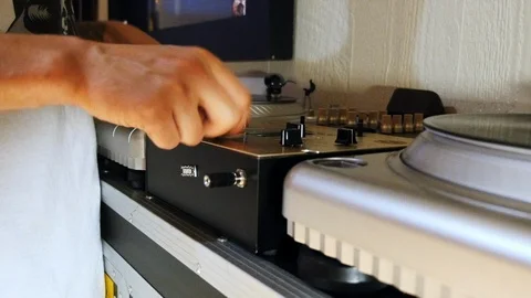 Mix and scratch, hands of a DJ on vinyl and mixer knobs. 스톡 동영상 90026401