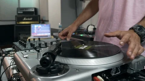 Mix and scratch, hands of a DJ on vinyl and mixer knobs. Video stock 92138452