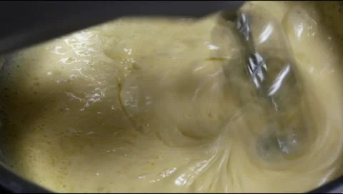 Mix the cake batter using a mixer from the eggs, flour and sugar Stock Footage 306759587