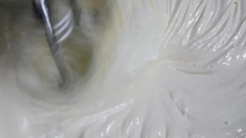 Mix the cake batter using a mixer from the eggs, flour and sugar Stock Footage 306759695