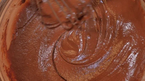 Mix the chocolate mixture with a kitchen whisk. making a chocolate cake. strawbe Stock Footage 111637094