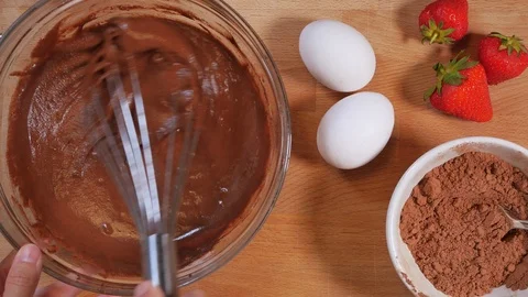 Mix the chocolate mixture with a kitchen whisk. making a chocolate cake. strawbe Stock Footage 111637304