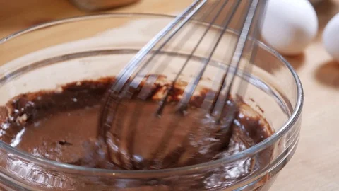 Mix the chocolate mixture with a kitchen whisk. making a chocolate cake. strawbe Stock Footage 111637826